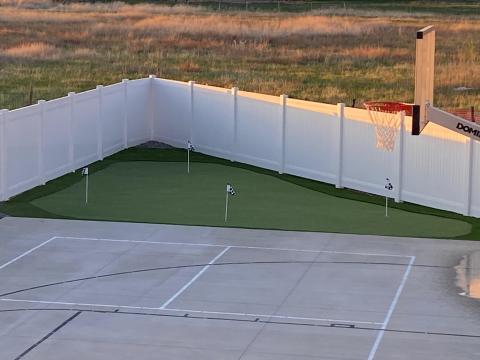 View of putting green corner of yard from deck